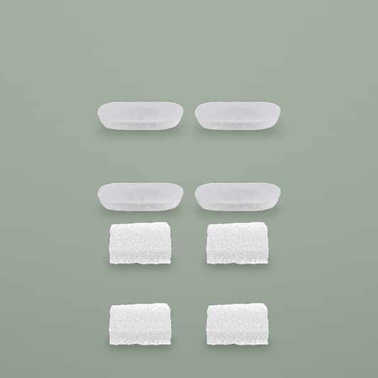 Four carbon filter pads and four foam pre-filters on a plain background.
