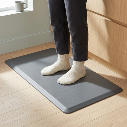 Someone standing on the grey anti-fatigue mat in wool socks, in a kitchen.